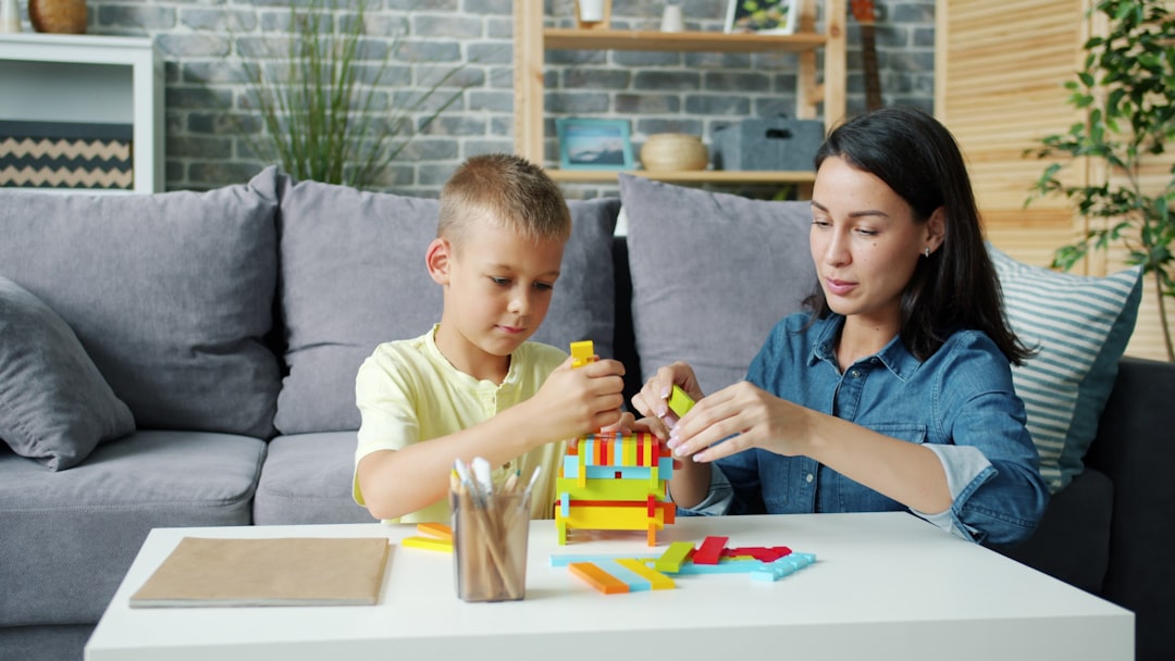 Woman and child enjoying a learning activity together outdoors